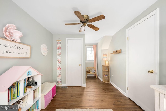 rec room featuring dark wood finished floors, visible vents, baseboards, and ceiling fan