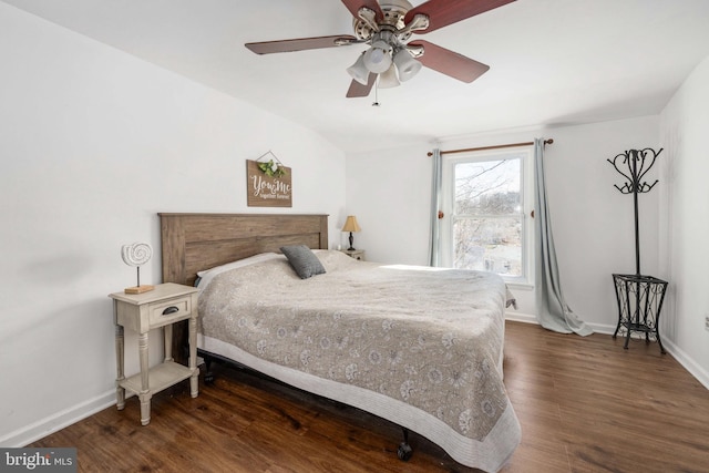 bedroom featuring a ceiling fan, baseboards, and wood finished floors