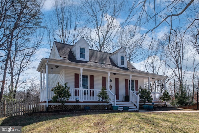 view of front facade featuring a porch, a shingled roof, a front yard, and fence