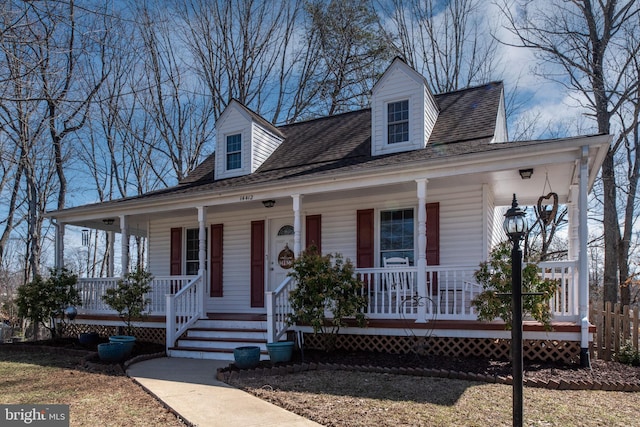 country-style home with a porch and a shingled roof