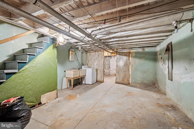 basement featuring washer / clothes dryer and sink