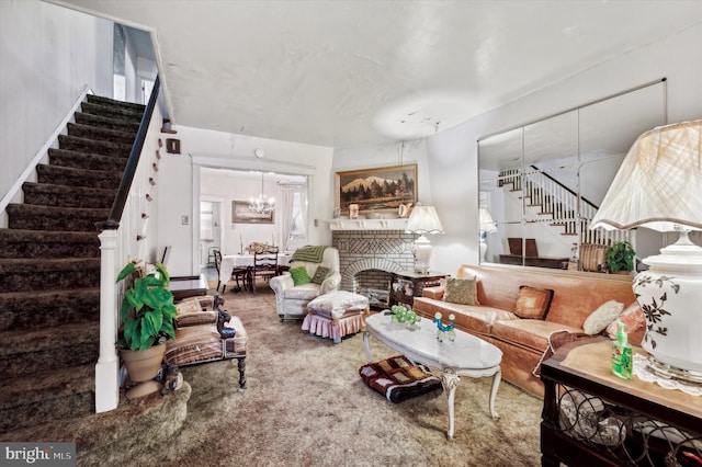 carpeted living room with a brick fireplace and an inviting chandelier