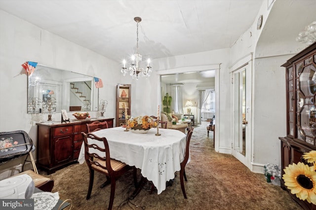 carpeted dining area with a notable chandelier