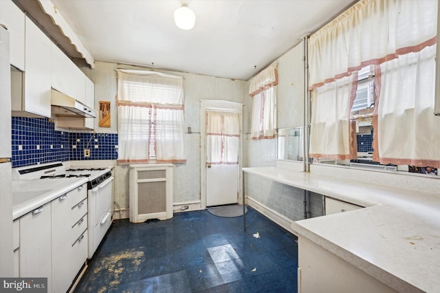 kitchen featuring tasteful backsplash, white cabinetry, and white gas range oven