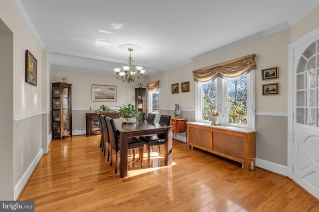 dining space with light wood-type flooring, radiator heating unit, an inviting chandelier, a baseboard radiator, and crown molding