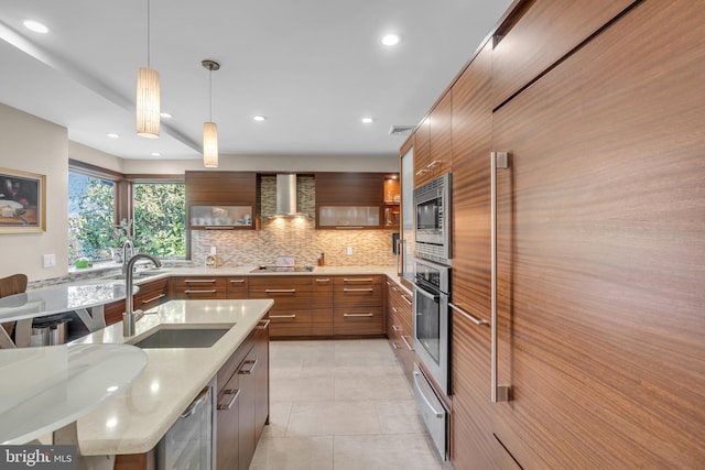 kitchen featuring hanging light fixtures, stainless steel appliances, sink, tasteful backsplash, and light tile patterned flooring