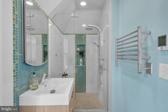 bathroom featuring vanity and a shower with shower door