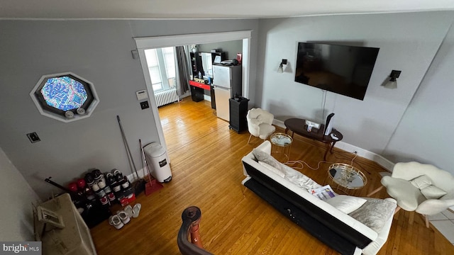 living room featuring hardwood / wood-style flooring and radiator heating unit