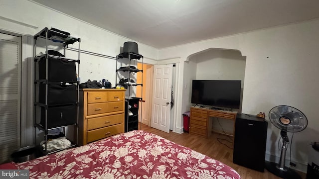 bedroom with dark wood-type flooring