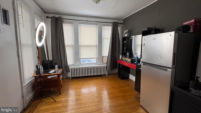 kitchen with radiator, refrigerator, and light hardwood / wood-style floors