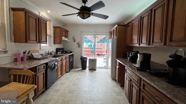 kitchen featuring sink, ceiling fan, stainless steel appliances, ornamental molding, and dark stone counters