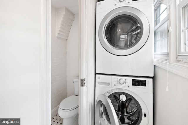 laundry room with laundry area and stacked washer / drying machine