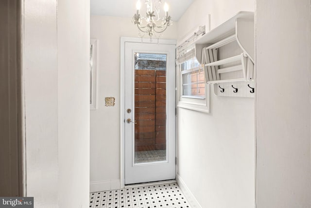 mudroom featuring baseboards and a chandelier