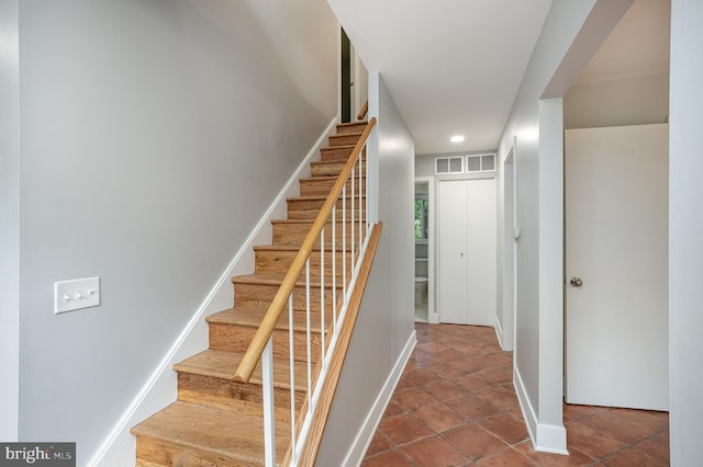 stairway with tile patterned flooring