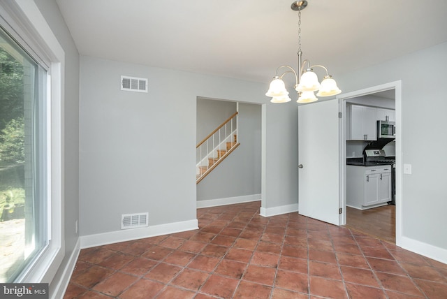 unfurnished dining area with tile patterned flooring and a notable chandelier