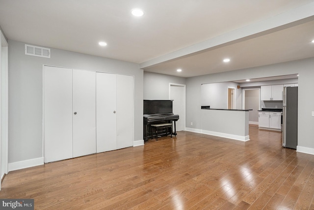 unfurnished living room featuring light hardwood / wood-style floors