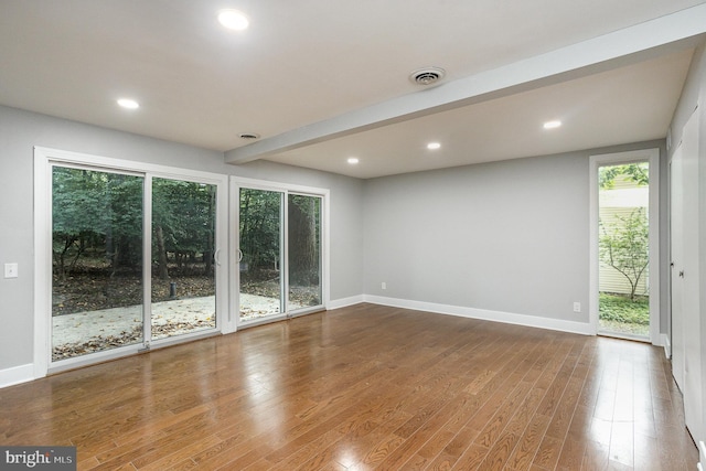 unfurnished room featuring hardwood / wood-style flooring