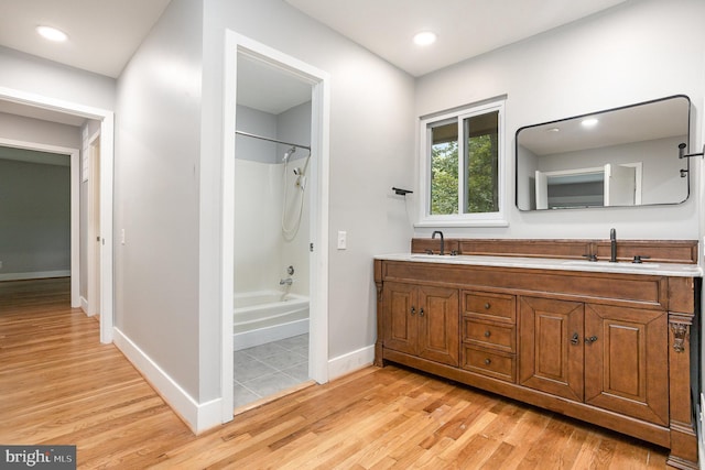 bathroom featuring vanity, bathing tub / shower combination, and hardwood / wood-style floors