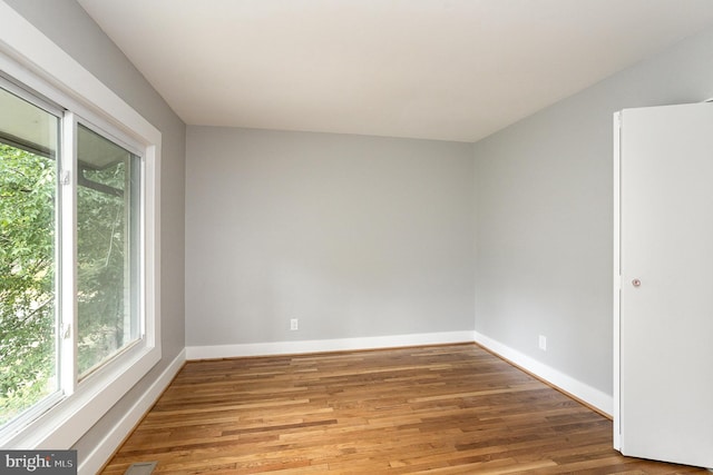 unfurnished room with wood-type flooring