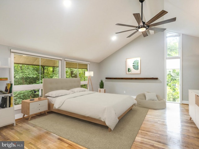 bedroom featuring ceiling fan, vaulted ceiling, and light hardwood / wood-style flooring