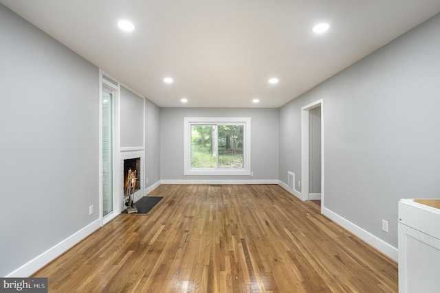 unfurnished living room with light hardwood / wood-style flooring