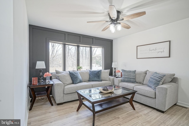 living room with ceiling fan and light hardwood / wood-style floors