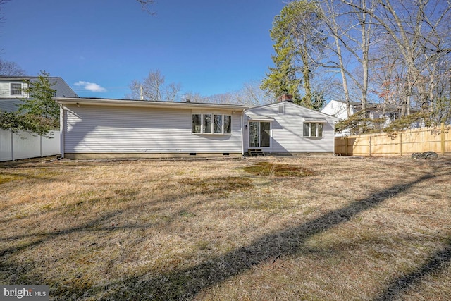 back of property featuring a lawn