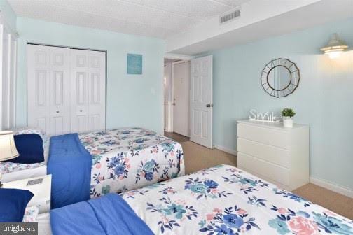 bedroom with carpet floors and a closet