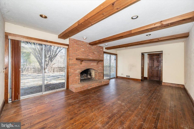 unfurnished living room featuring hardwood / wood-style floors, a brick fireplace, plenty of natural light, and baseboards