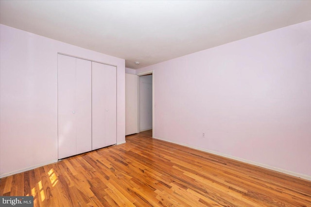 unfurnished bedroom featuring a closet and wood finished floors