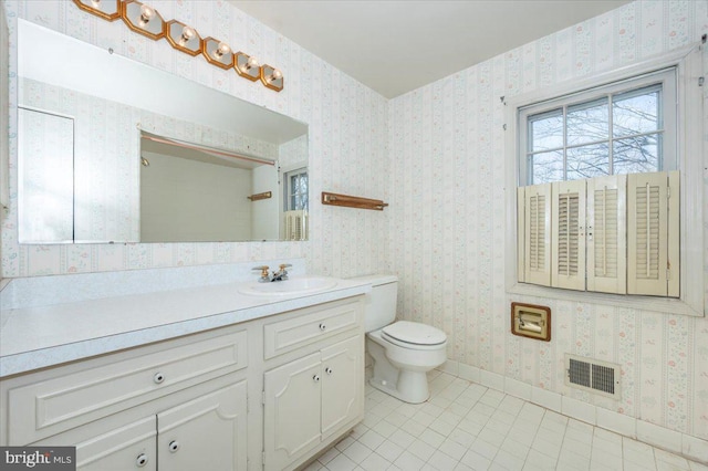 bathroom with tile patterned flooring, visible vents, wallpapered walls, baseboards, and toilet