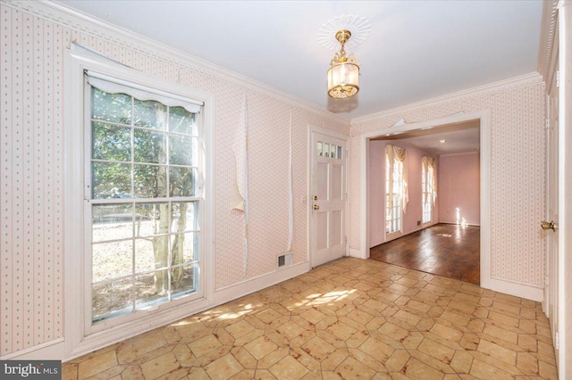 interior space with wallpapered walls, plenty of natural light, and ornamental molding