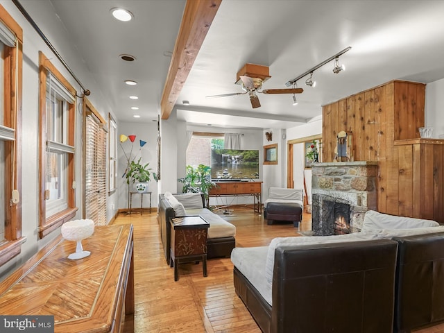 3137 18th St NE, Washington, DC 20018 - living area with a fireplace, beam ceiling, a ceiling fan, and light wood-style flooring