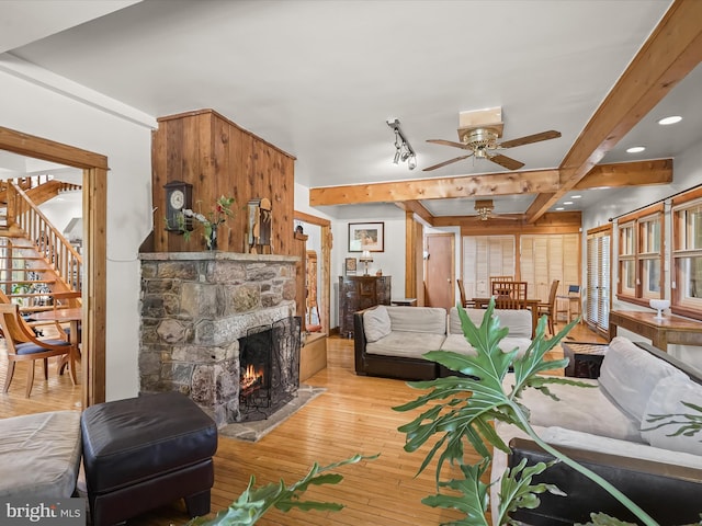 3137 18th St NE, Washington, DC 20018 - living area featuring recessed lighting, hardwood / wood-style floors, beamed ceiling, a stone fireplace, and a ceiling fan