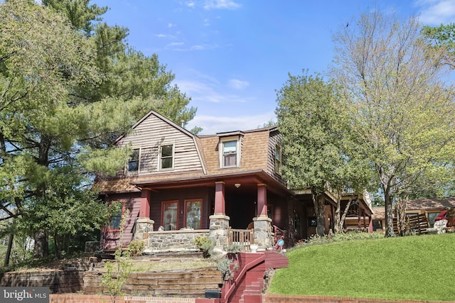 3137 18th St NE, Washington, DC 20018 - view of front of house featuring a front yard, a porch, stairway, and a gambrel roof