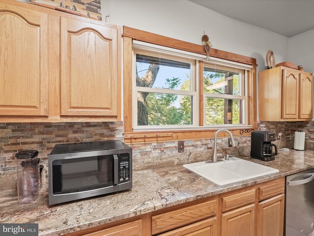 3137 18th St NE, Washington, DC 20018 - kitchen with light brown cabinetry, backsplash, appliances with stainless steel finishes, and a sink