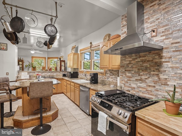 3137 18th St NE, Washington, DC 20018 - kitchen featuring wall chimney range hood, a sink, light tile patterned flooring, backsplash, and appliances with stainless steel finishes