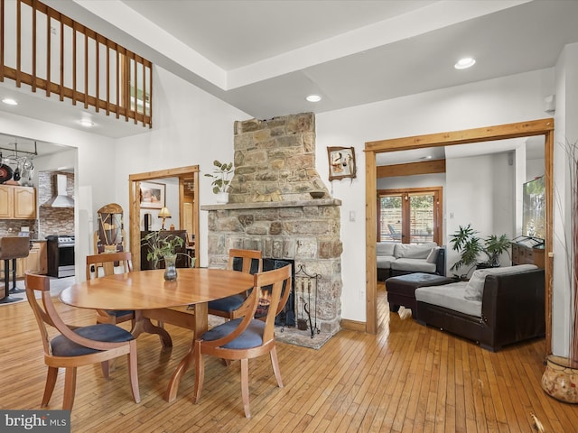 3137 18th St NE, Washington, DC 20018 - dining area with baseboards, a fireplace, and light wood finished floors