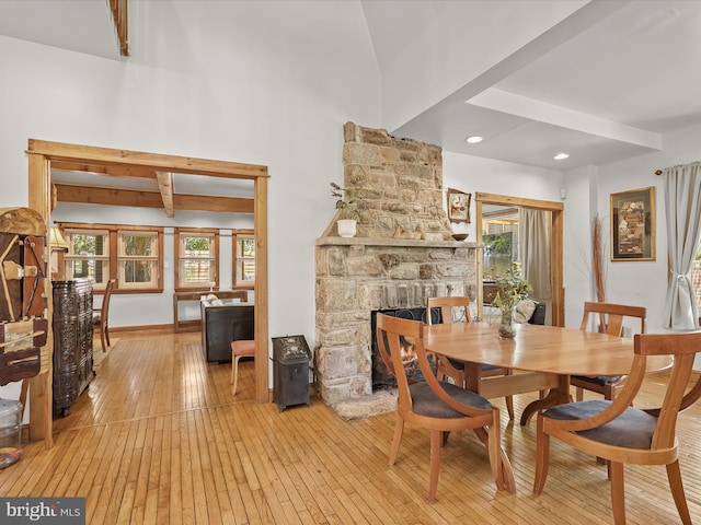 3137 18th St NE, Washington, DC 20018 - dining area with beam ceiling, a wealth of natural light, light wood-type flooring, and a stone fireplace