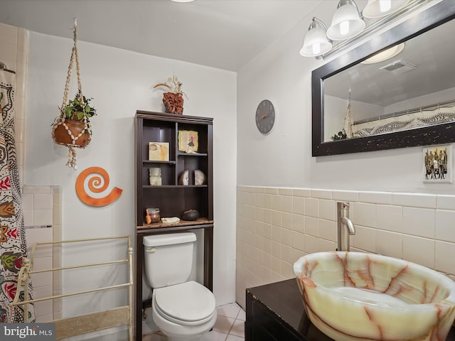 3137 18th St NE, Washington, DC 20018 - full bath with visible vents, toilet, tile walls, vanity, and wainscoting