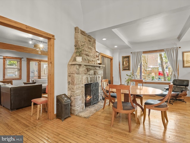 3137 18th St NE, Washington, DC 20018 - dining area with a stone fireplace, beam ceiling, and light wood-type flooring