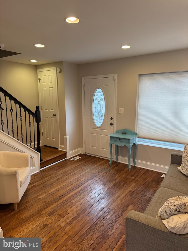 foyer entrance with recessed lighting, baseboards, stairway, and hardwood / wood-style floors