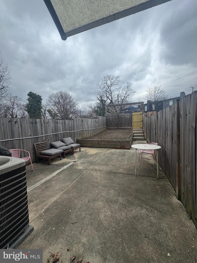 view of patio / terrace with a fenced backyard and central air condition unit