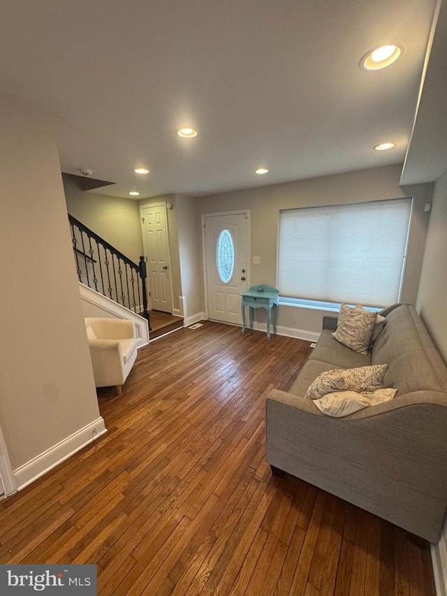 entrance foyer featuring recessed lighting, stairway, wood-type flooring, and baseboards