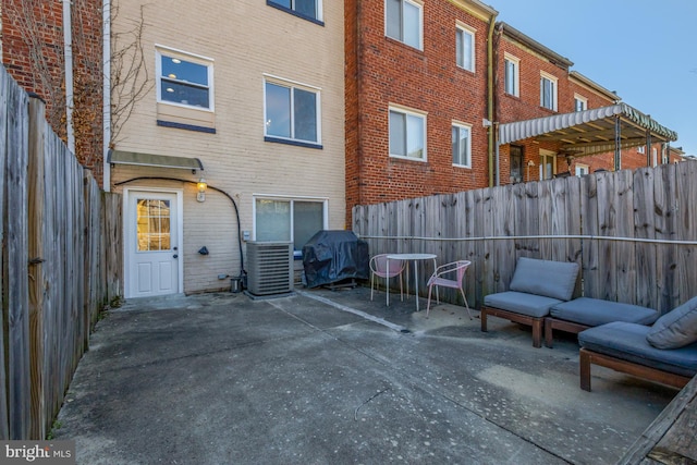 view of patio / terrace featuring a grill, cooling unit, and a fenced backyard