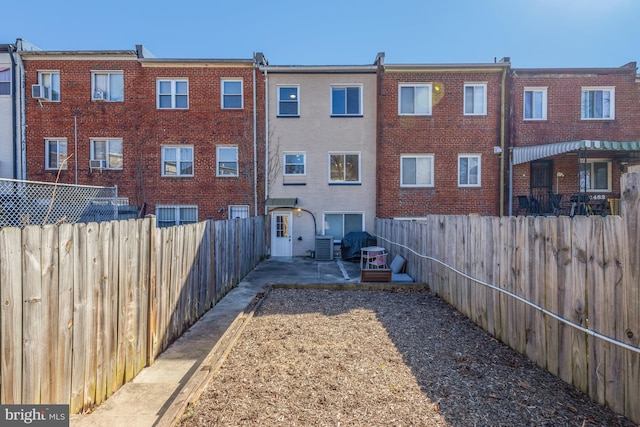 back of property featuring a patio area, a fenced backyard, and brick siding