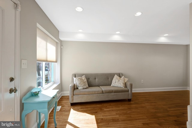 living room with baseboards, wood finished floors, and recessed lighting