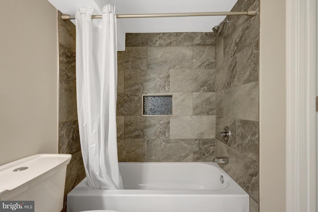 bathroom with shower / bath combo with shower curtain and toilet