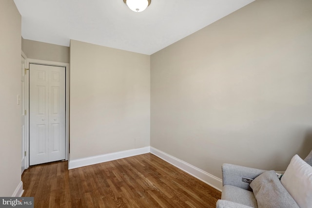 unfurnished room featuring wood finished floors and baseboards