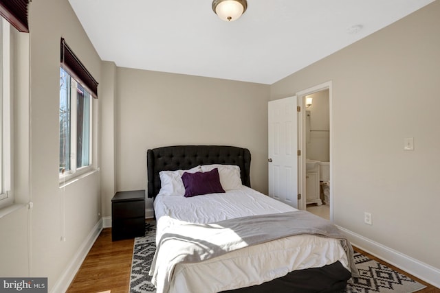 bedroom with light wood-style flooring and baseboards